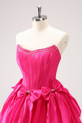 Robe de bal fuchsia mignonne, coupe trapèze, bustier, à volants, perles et nœuds