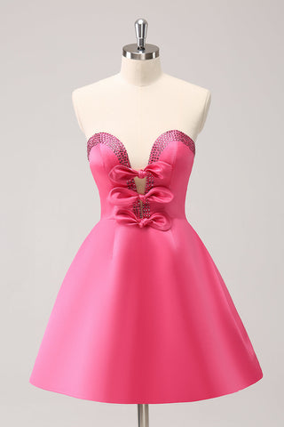 Robe de bal rose fuchsia ravissante, coupe trapèze, sans bretelles, découpée et ornée de perles