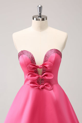 Robe de bal rose fuchsia ravissante, coupe trapèze, sans bretelles, découpée et ornée de perles