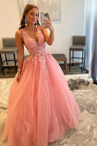 Robe de bal rose poudré en tulle, coupe trapèze, col en V et fente.