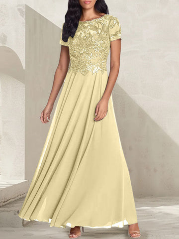 Vestido largo de corte A, color gris carbón, con escote redondo y detalles de pedrería, ideal para la madre de la novia.