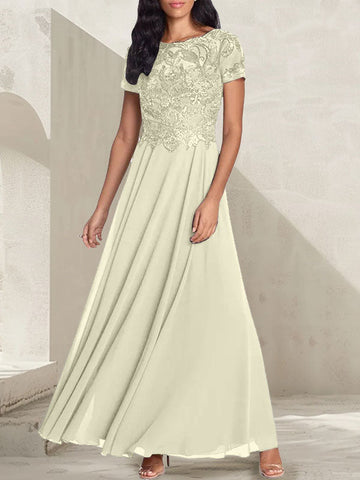 Vestido largo de corte A, color gris carbón, con escote redondo y detalles de pedrería, ideal para la madre de la novia.