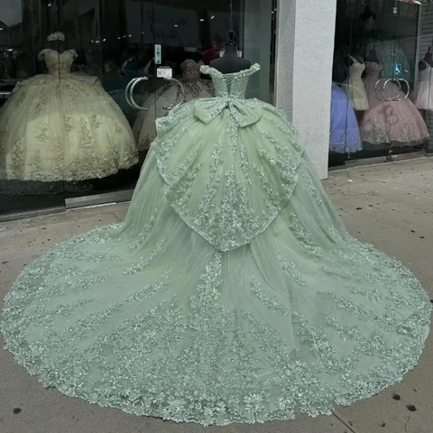 Robe de bal de quinceañera vert menthe luxueuse à épaules dénudées, ornée d'appliqués de tulle, de perles et d'un nœud à volants (Y8125)