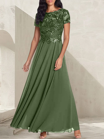 Vestido largo de corte A, color gris carbón, con escote redondo y detalles de pedrería, ideal para la madre de la novia.