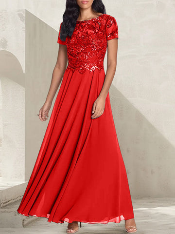 Vestido largo de corte A, color gris carbón, con escote redondo y detalles de pedrería, ideal para la madre de la novia.