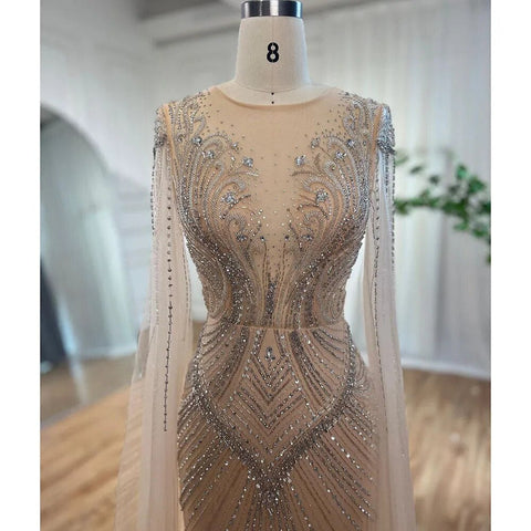Vestidos de noche elegantes con cuentas, estilo sirena, color nude, con mangas tipo capa, de inspiración árabe. Vestidos de lujo para mujer, ideales para bodas y fiestas. Colección 2025. LA72165 