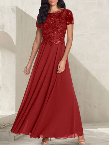 Vestido largo de corte A, color gris carbón, con escote redondo y detalles de pedrería, ideal para la madre de la novia.