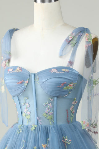 Lindo vestido corto de fiesta de bienvenida en color gris azulado, corte en A, con tirantes finos y apliques.