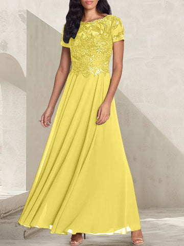 Vestido largo de corte A, color gris carbón, con escote redondo y detalles de pedrería, ideal para la madre de la novia.