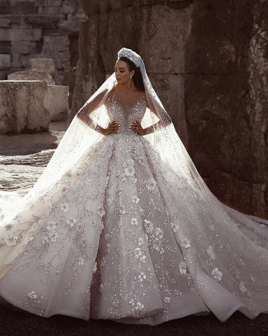 Vestidos de novia de corte princesa con escote corazón, mangas largas, encaje floral y cuentas