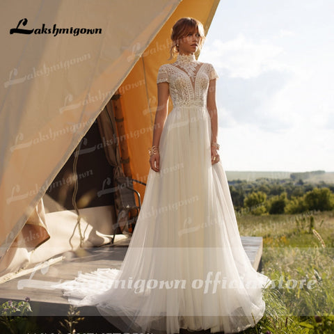 Robe de mariée bohème vintage Baoleely en dentelle et tulle, col haut, manches courtes, coupe trapèze, style bohème, ivoire, élégante